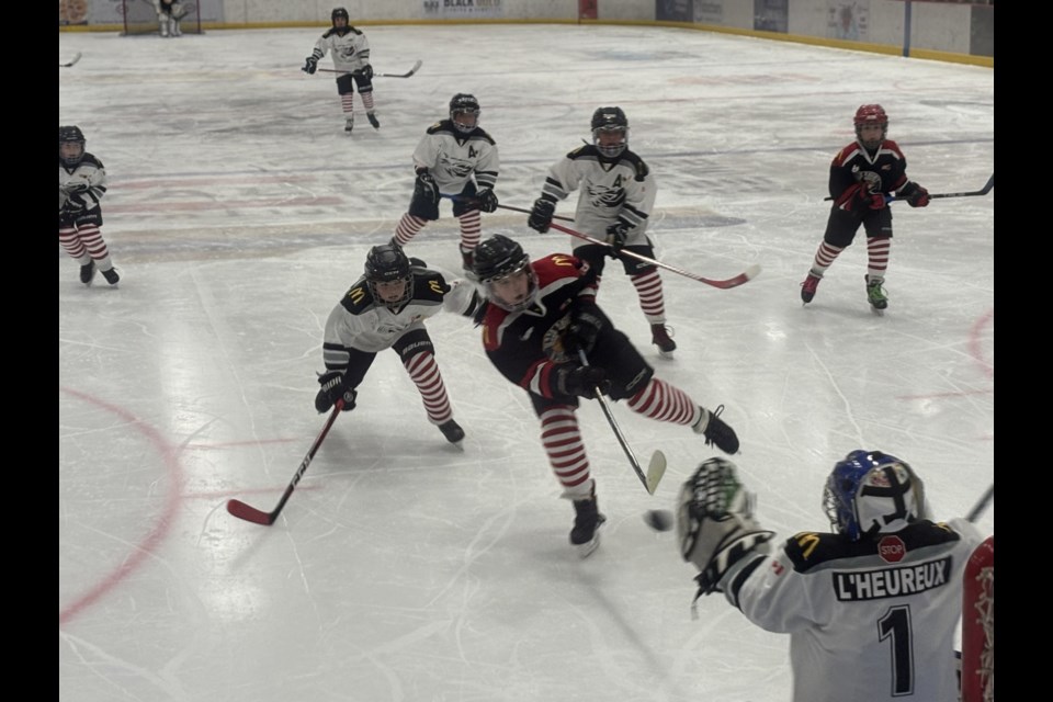 A player from Wood Buffalo Eagles takes a shot on goal as Cold Lake U 11 battle it out during the Winterland Invitational tournament early Sunday morning.