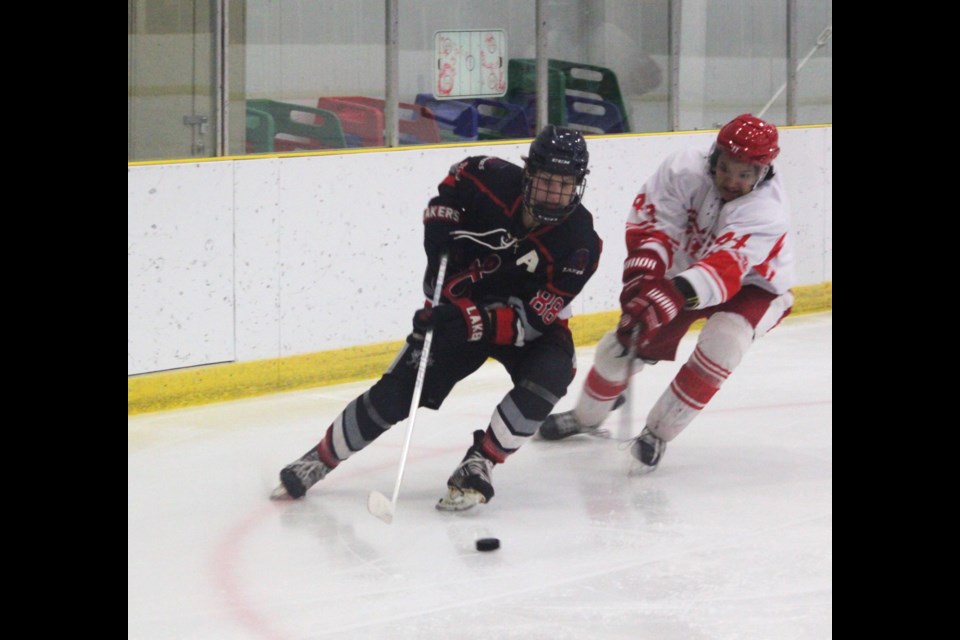 Lac La Biche Lakers forward Rob Rendle is pursued by Harlan Noskey of the High Prairie Red Wings during Friday’s game at the Bold Center which High Prairie won 7-5. Chris McGarry photo. 