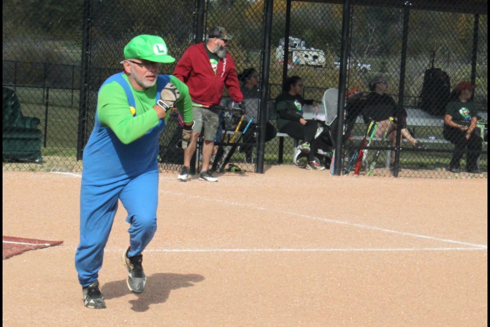 Run Luigi, run... Kevan Pleshka, a member of the Luigi team takes off for first base during a game against team Yoshi, who won by a score of 16-12. Chris McGarry photo.