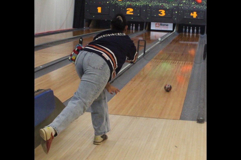 Maria Kumpala, like many of those who participated in this year’s Bowl For Kids’ Sake fundraiser for the Lac La Biche Big Brothers Big Sisters program, wore hockey jerseys in keeping with the theme of the event. Kumpala watches as the ball she has just thrown rolls down the lane towards the pins. Chris McGarry photo.