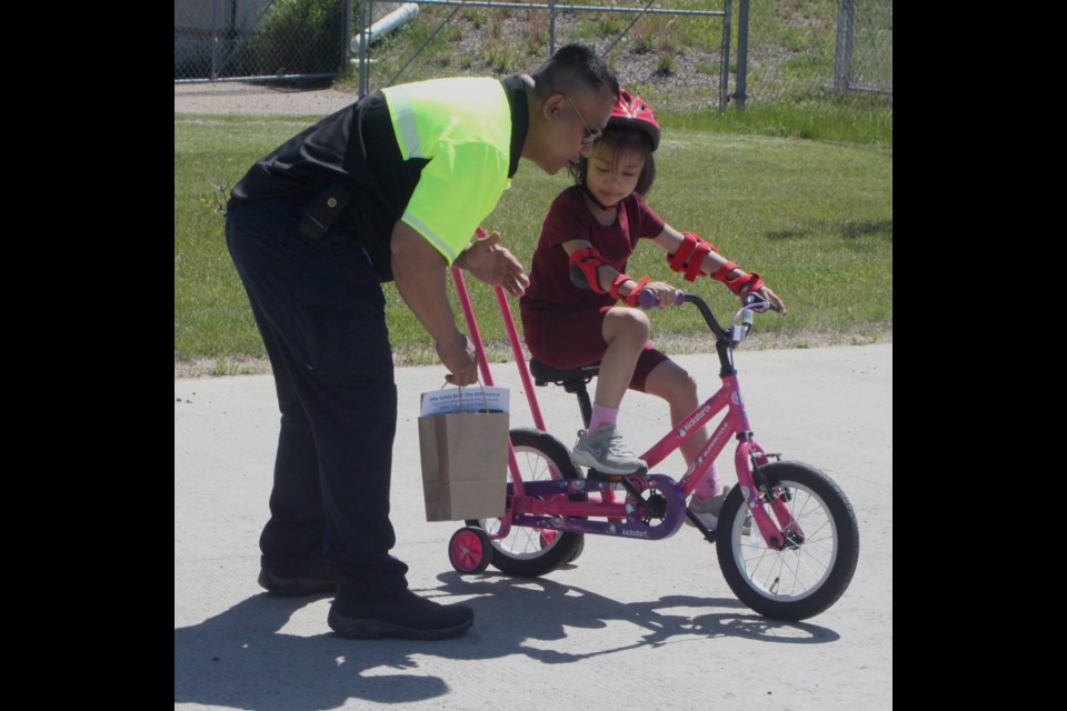 Marvin Bautista gives some pointers to his daughter, Rafaella, during the bike rodeo that took place at the Protective Services Building in Lac La Biche on Saturday, June 22. Chris McGarry photo. 