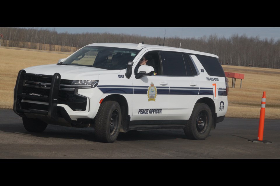 Montana Thompson, a cadet in the community peace officer program, drives through a course marked by orange pile ons. Chris McGarry photo. 