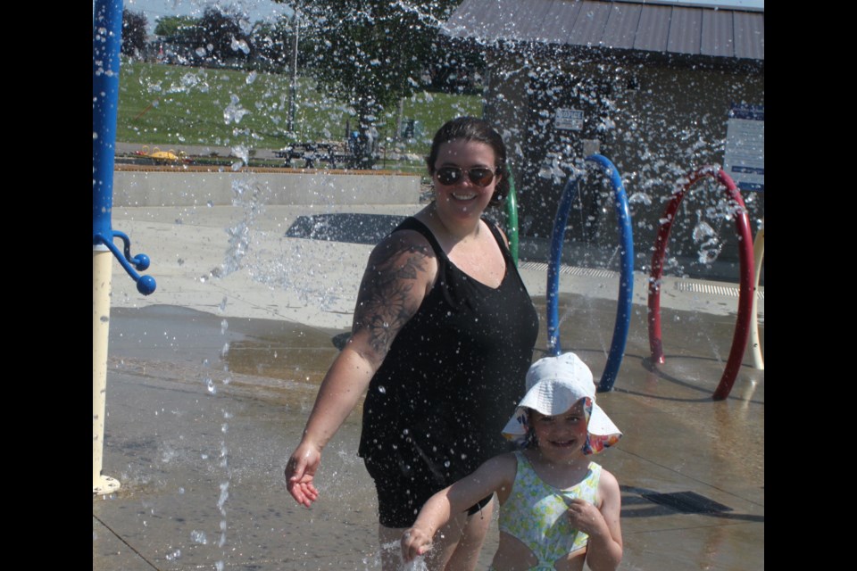 Hayley MacDonald and her daughter, Regan, enjoyed themselves in the cool, refreshing waters of the splashpads at McArthur Park. Chris McGarry photo. 