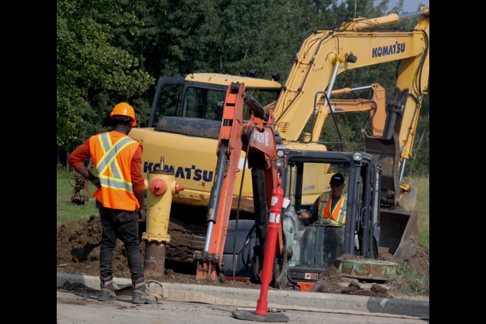 A backhoe works around an area on Nipewon Road where a fire hydrant was being excavated for repairs. Chris McGarry photo. 