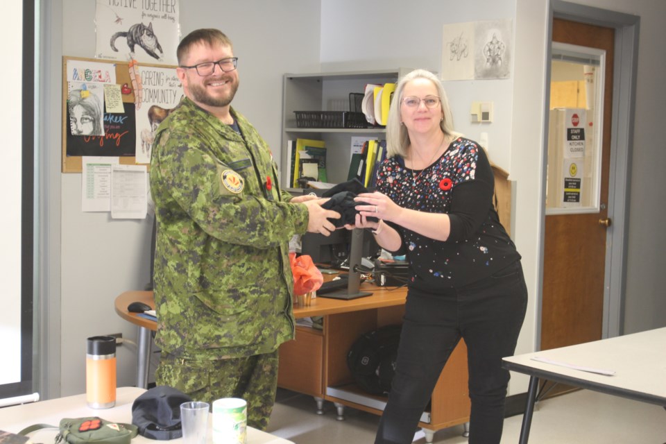 The Cold Lake Outreach School held a Remembrance Day ceremony on Nov. 7. Warrant Officer Jonathan McArthur was honored with a special gift from the school, presented by teacher Angela Kynaston, in recognition of his inspiring story and contributions to the commemoration.
