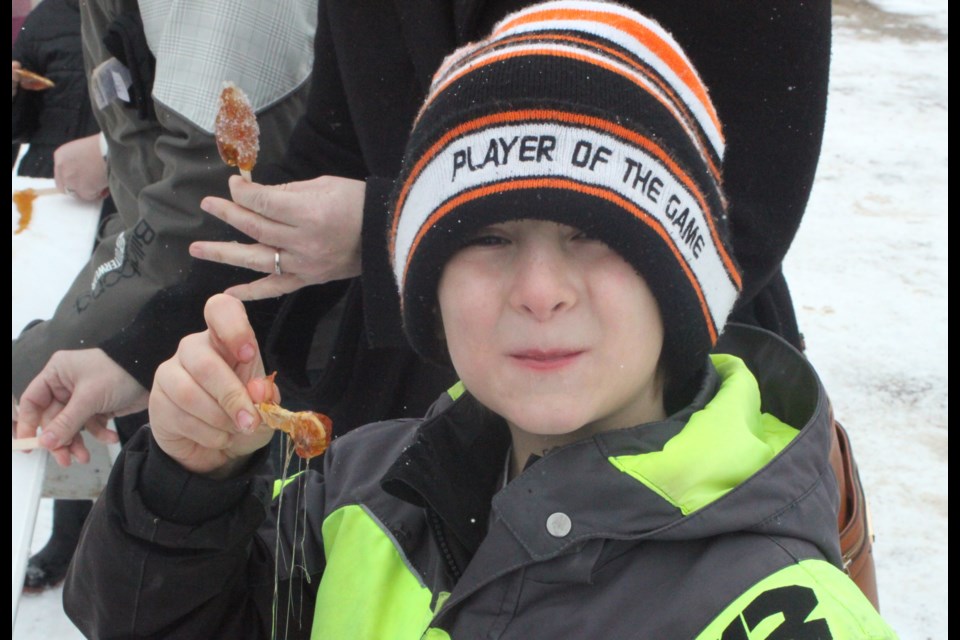 Oxley Boisvert enjoys some of the maple syrup taffy that was on offer at the La Cabane å Sucre event, which took place at the Plamondon-Lac La Biche office of the French Canadian Association of Alberta (ACFA) on March 15. The day of fun games, maple syrup and music was held as part of Alberta Francophonie Month events. Chris McGarry photo. 