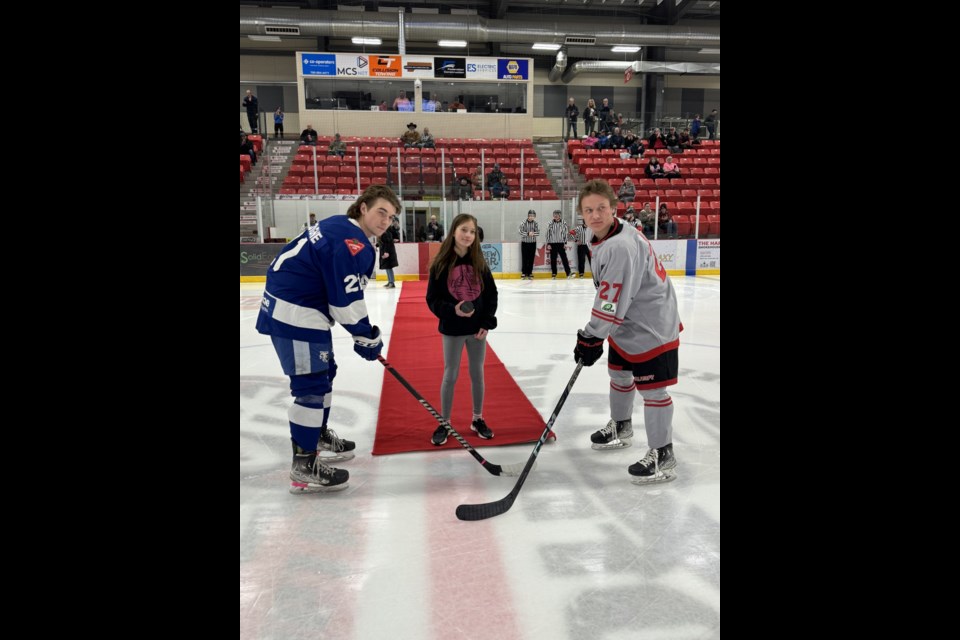 Alexa Williams, winner of the Cold Lake Bully Free Committee's annual "Pink the Rink" colouring contest, takes center ice for the ceremonial puck drop at Imperial Oil Place Arena in the Cold Lake Energy Centre, promoting anti-bullying awareness.

Photo courtesy of Jacki Cook.