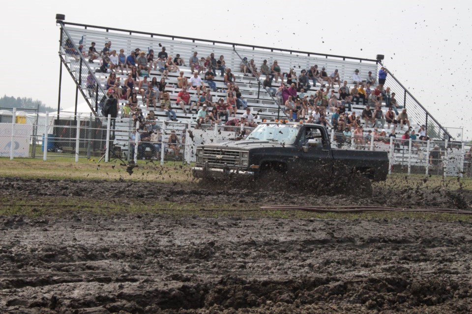 A Chevy shortbox splashes through the mud in front of the grandstand at the 2023 Plamondon Mud Bogs. Chris McGarry photo. 