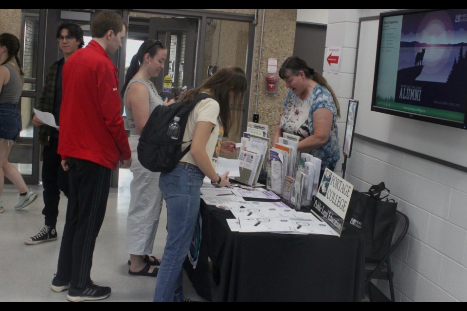 A group of students check out one of the information booths set up inside the Portage College Lac La Biche campus. Student orientation events were held all the Portage College Lac La Biche, St. Paul, and Cold Lake campuses. Chris McGarry photo. 