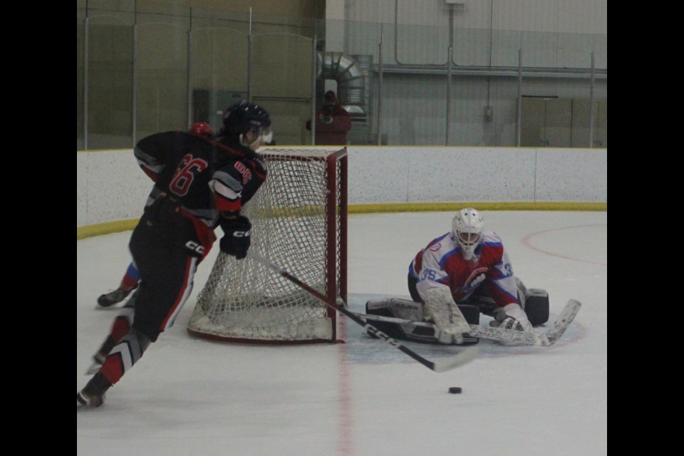 Northern Alberta Lightning goalie Luka Dolenc gets ready to defend his net from an attack by Lac La Biche Lakers defenseman Quinten Quinney during a game at the Bold Centre on Feb. 7. The Lakers won the contest 15-0. Chris McGarry photo. 