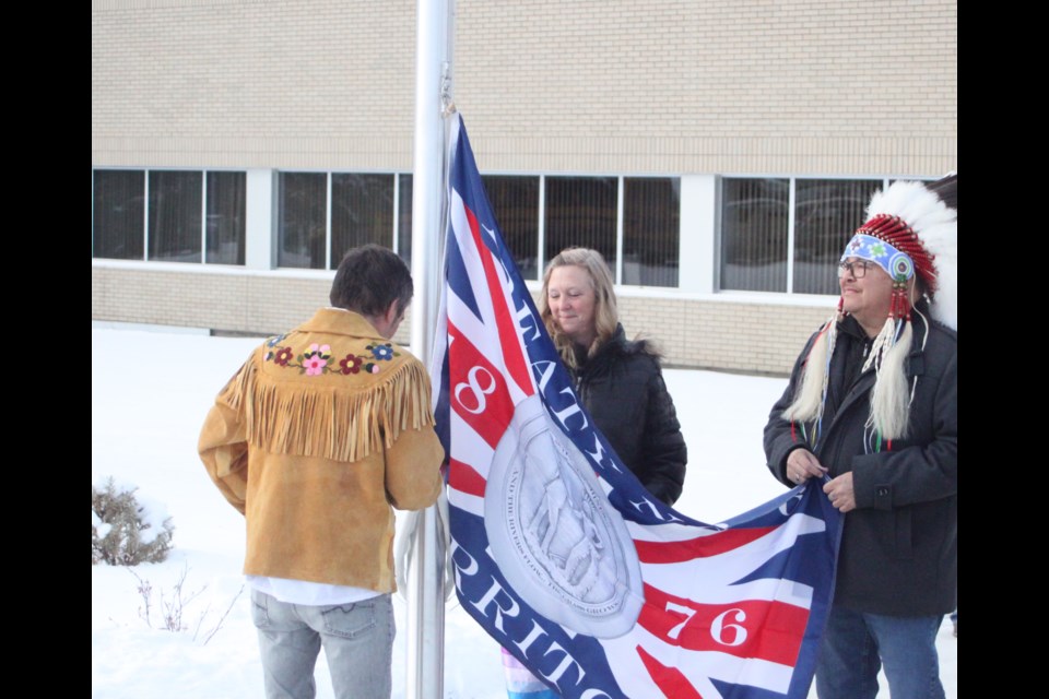 Robert Rayko, Portage College’s cultural and community facilitator, Nancy Broadbent, president of Portage College, and Gary Lameman, chief of Beaver Lake Cree Nation, prepare the Treaty Six flag to be hoisted during the flag-raising ceremony that took place at the college’s Lac La Biche campus on Friday, Nov. 29. Chris McGarry photo. 