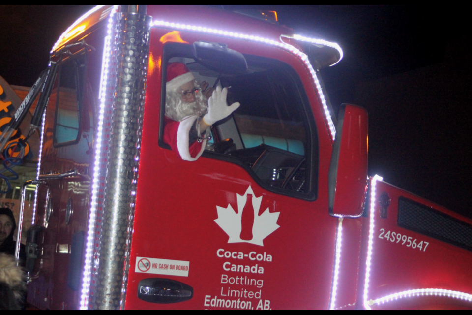 Santa Clause waves as he travels down Lac La Biche's Main Street in a Coca Cola truck during the 2023 Light up the Night Parade. Chris McGarry photo. 