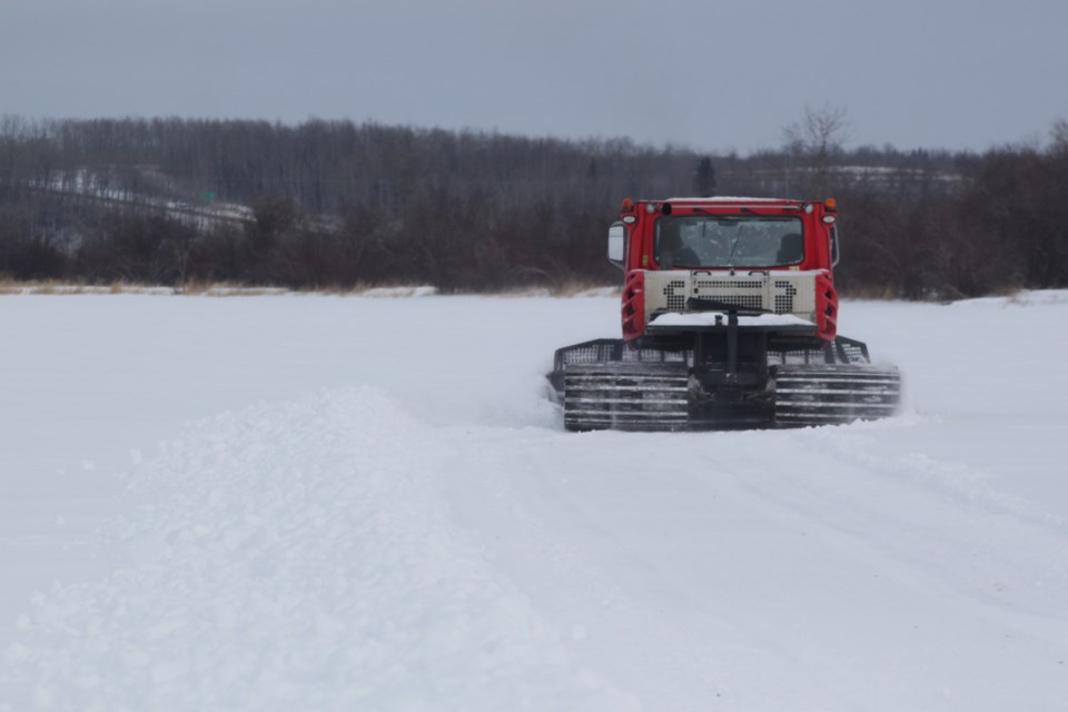 A snowcat machine operated by Gordon Kozakevich clears snow from Lac La Biche Lake. Volunteers begin site preparation on Feb. 12 for the 2025 Lac La Biche Ice Festival, which is taking place from Feb. 28-March 2. Chris McGarry photo. 