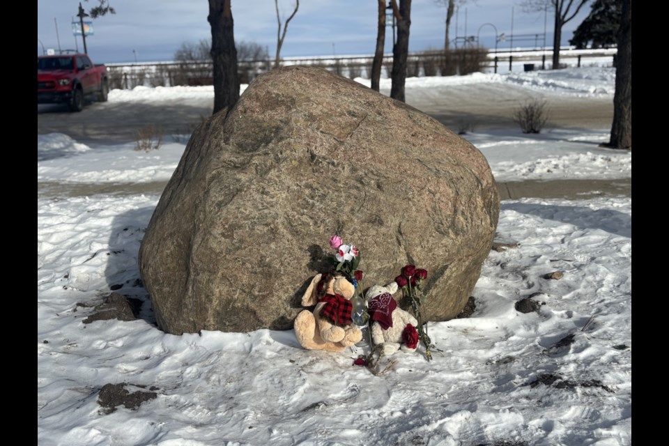 A small memorial was placed where a woman was found dead between the totem poles.
Photo Credit: Chantel Downes