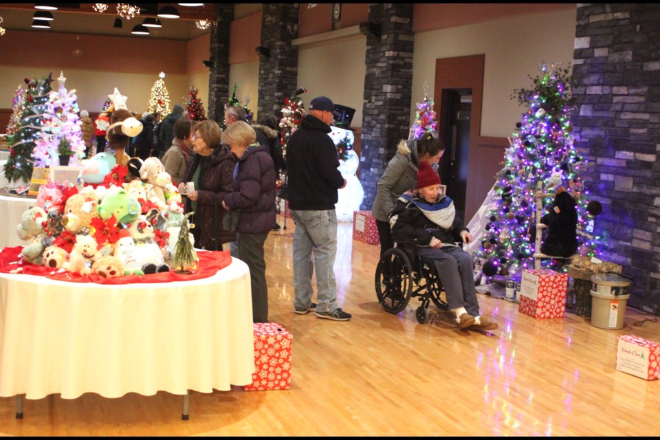 People looking the brightly coloured Christmas trees inside of the Bold Center Community Hall on the morning of Friday, Nov. 22. Chris McGarry photo. 