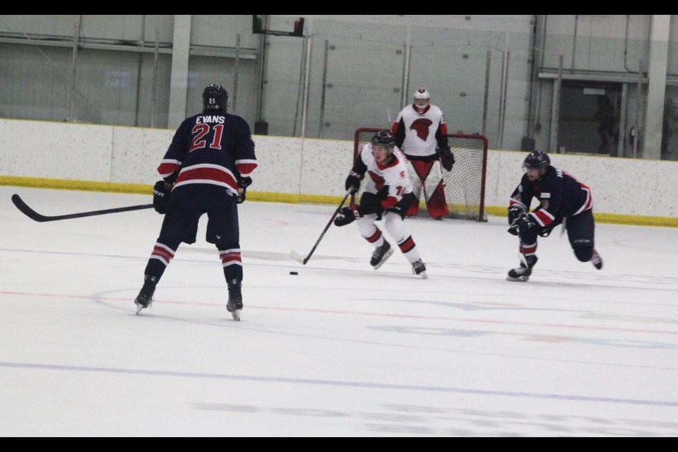 Tye Evans and Xavier Halterman of the Portage College Voyageurs prepare to stop SAIT Trojans defenseman Taylor Gold from advancing further during Friday’s game at the Bold Center. SAIT won the contest 4-2. Chris McGarry photo.