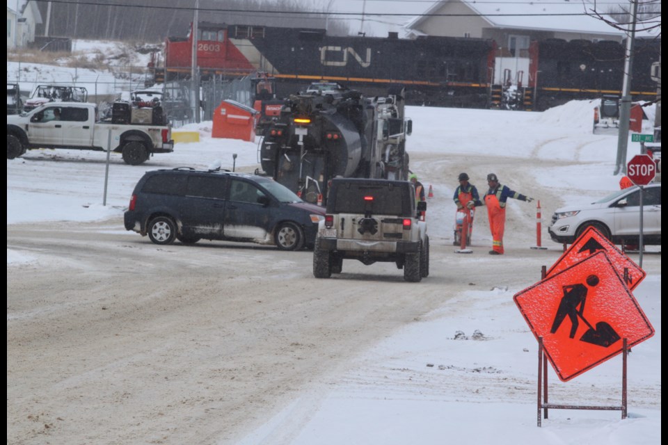 Workers direct traffic through the intersection of 100 Street and 101 Avenue in the hamlet of Lac La Biche on Tuesday, Jan. 21 as crews performed hydro vac excavation work. The work was being done to prepare the area for the third and final phase of the $32.5 million Main Street Revitalization project, which is set to get underway this spring. Chris McGarry photo. 