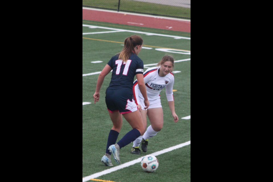 Voyageur Allison Shapka is obstructed by Chantelle Kirk of the Northwestern Polytechnic Wolves. Chris McGarry photo. 