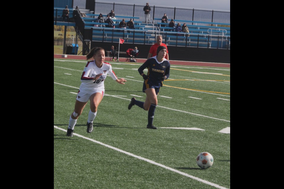 Reanna Brownlee chases down the ball as a small crowd watches in the background during Saturday’s contest against the Concordia University of Edmonton Thunder, which the visiting won 12-0. The match that followed between the Voyageur men and Thunder resulted in a 3-1 victory for the visiting team. Chris McGarry photo. 