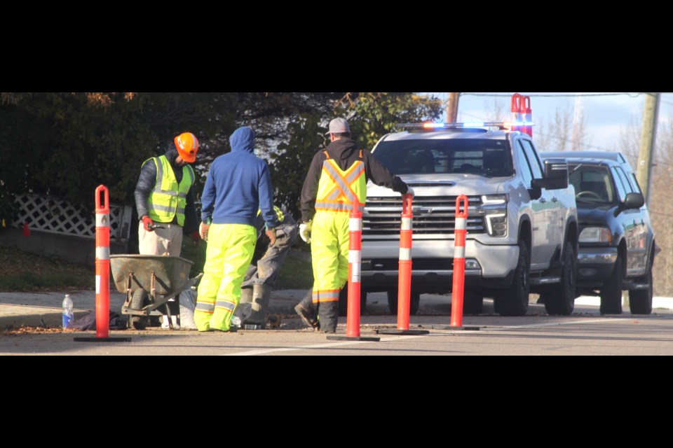 Crews bore holes on a section of sidewalk along 100 St on Wednesday, Oct. 23 for the purpose of soil sampling to assist with the engineering design of the Highway 36 to 91 Avenue water and sewer replacement project, which is expected to be finished in October. Chris McGarry photo. 