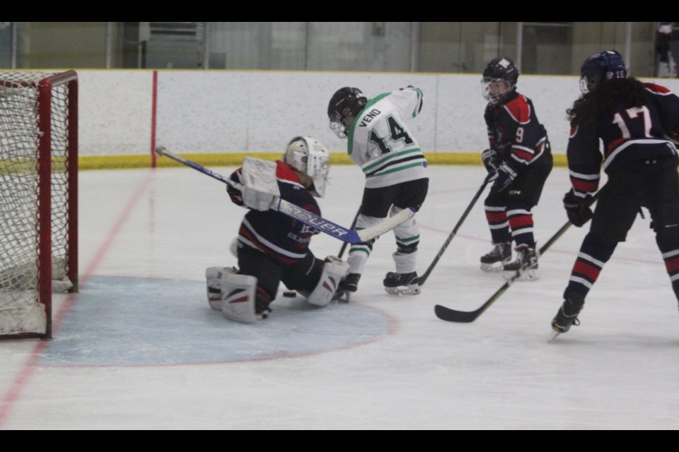 Lac La Biche U11-1 Clippers’ goaltender Weston Wladyka rushes to stop an attack by Duke Veno of the Smoky Lake Stars Green. Smoky Lake won the 10-4 meeting between the two teams, which took place at Lac La Biche’s Bold Centre on Friday, Jan. 31. Chris McGarry photo. 