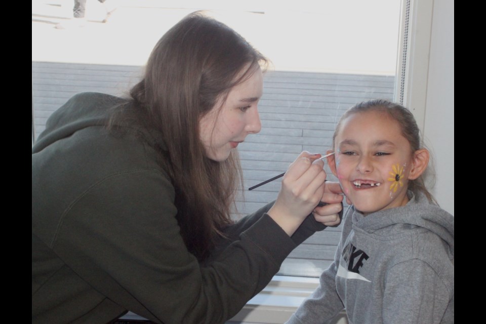 Zariha Gladue gets her face painted by Zoya Ennis at the kid’s carnival for the 2025 Lac La Biche Ice Festival, which was held at McArthur Place on March 1. Chris McGarry photo. 