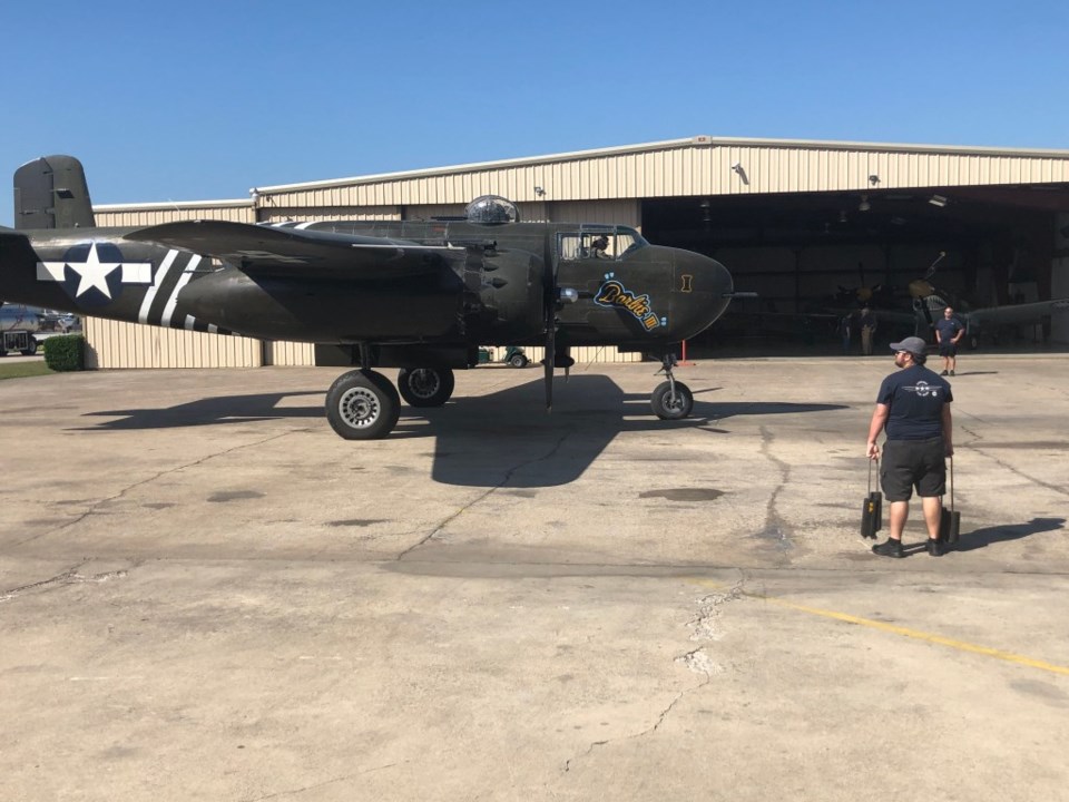 A vintage war aircraft from the Cavanaugh Flight Museum lands at Addison  Airport in Addison, Texas, Friday, May 22, 2020. The aircraft along with  other vintage war birds flew over several medical