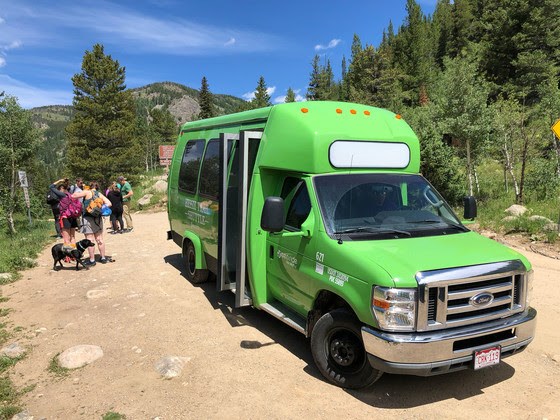 Hessie Trail Shuttle bus at the Hessie Trailhead, which is a popular access point to U.S. Forest Service lands and trails, on June 23, 2018. Boulder County operates the free shuttle service on weekends and holiday  in summer and fall to carry passengers from Nederlandâs RTD Park-n-Ride to the Hessie Trailhead. The Hessie Trailhead shuttle program began in the summer of 2012 to address the issue of increased parking and traffic congestion on the way to the trailhead. 