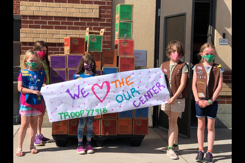 Troops from 77918 displaying their stack of donations. (L to R) Olive Wilson, Brook Allard, Mia Mondello, Linden Chenault & Ellie Sears