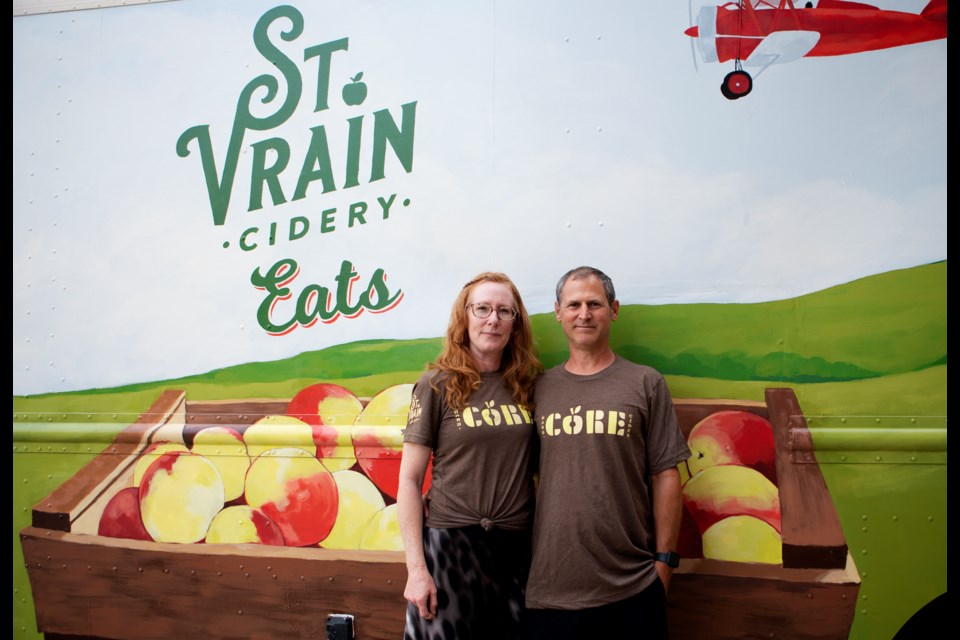 St. Vrain Cidery  owners  Cindy Landi and Dean Landi stand infront of the cideryâs food truck on July 28. The food truck is currently closed as the Longmont company searches for a new chef. Photo by Ali Mai | ali.mai.journo@gmail.com