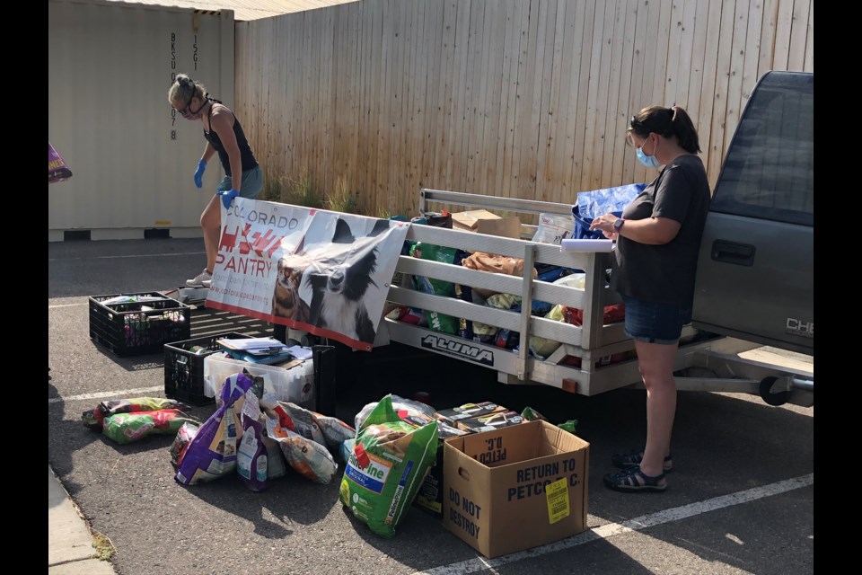 Colorado Pet Pantry volunteers help find food for Diane Carson's pets.