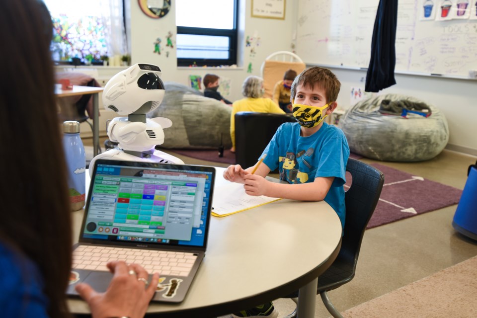 Larrissa Mangione, Soaring Heights PK-8 Affective Needs Teacher, with Misty robot and student Robert Tussey | Courtesy photo