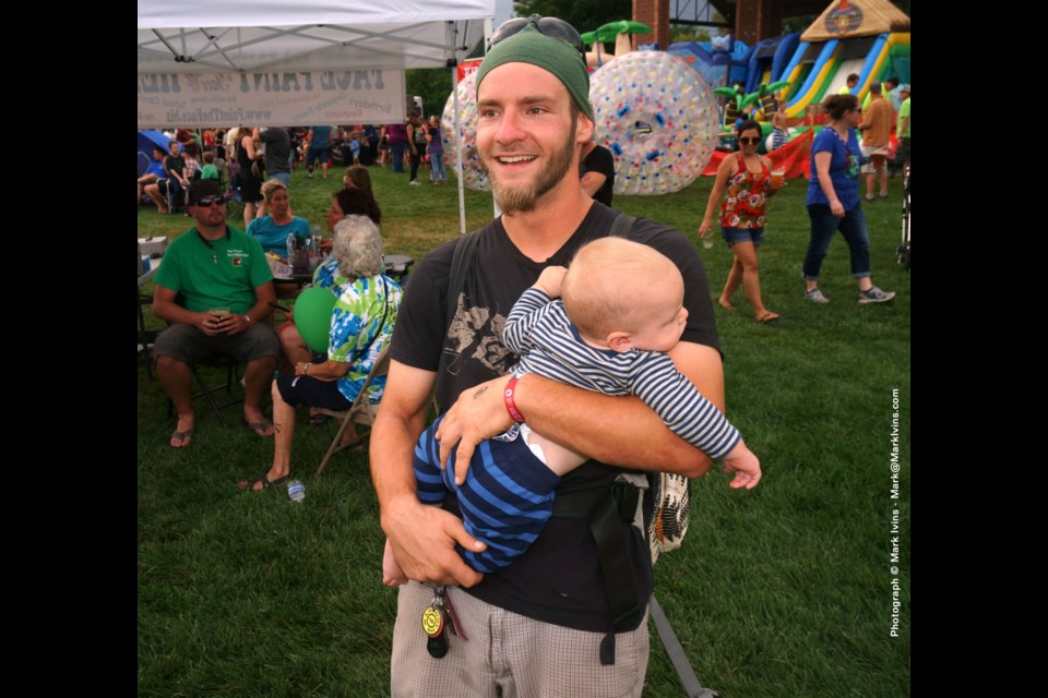 Father with Child at Leftapalooza Longmont, CO &#8211; Photograph by Mark Ivins