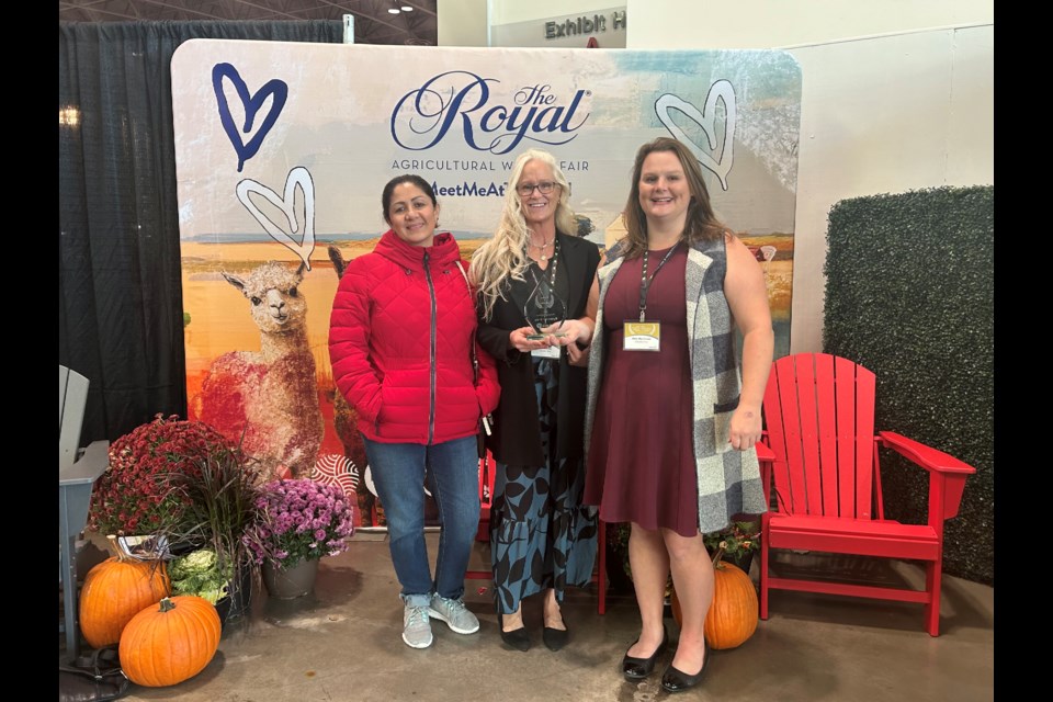 Midland's Operation Grow won an Ontario Excellence in Agriculture award at the Royal Winter Fair. Seen with the trophy are Veronica Peña, left, Corrine Flude and Haily MacDonald.