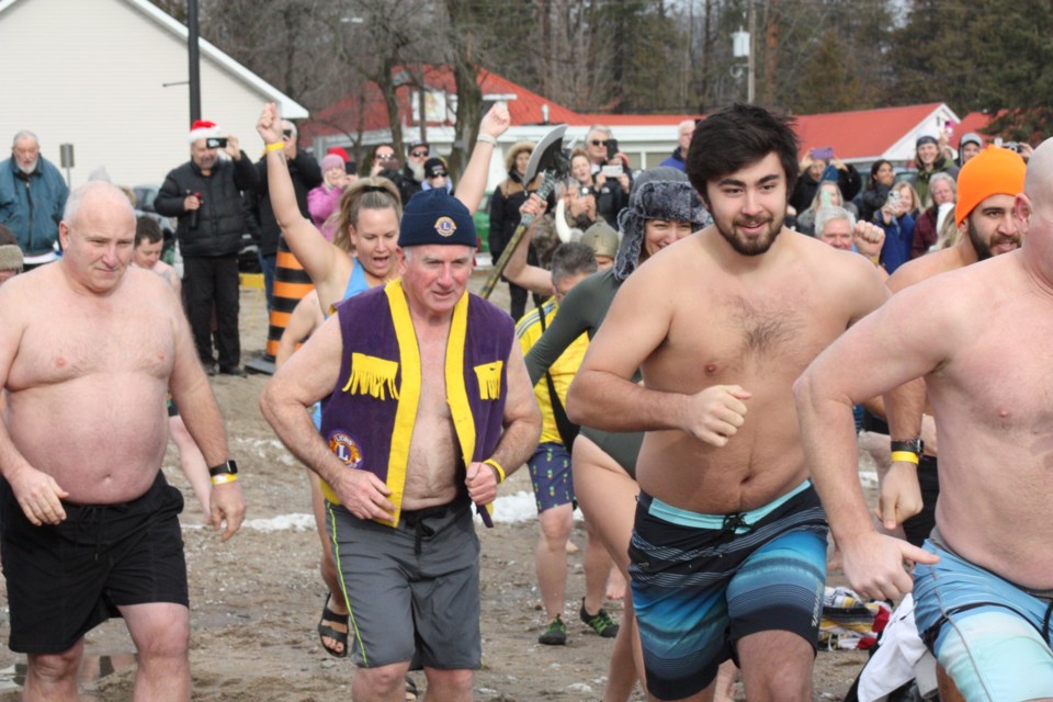 Running into the frigid waters during 2023 dip.