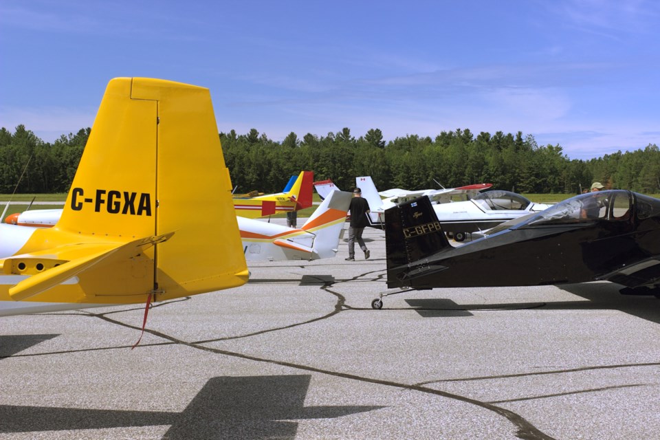 Visitors tour the various planes on display at the Huronia Airport summer fly-in Saturday.