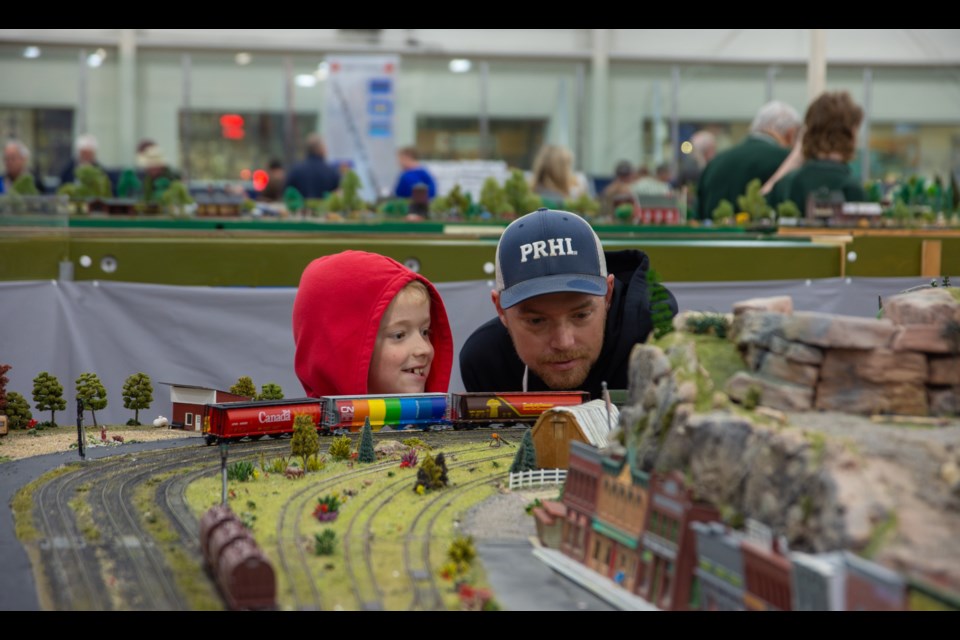 “My favourite part is the trains and the horn,” said Demetrius Salamone, shown with Brian Killick as they watch the Barrie Allandale Railway Modellers’ train come around the bend at Saturday’s Midland District Railroad Club Train Show.