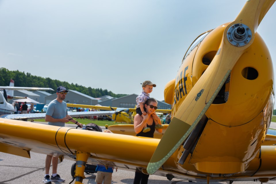 Kayla and Kyle Connolly with their son Boone checking out their favourite plane provided by the Edenvale Classic Aircraft Foundation.