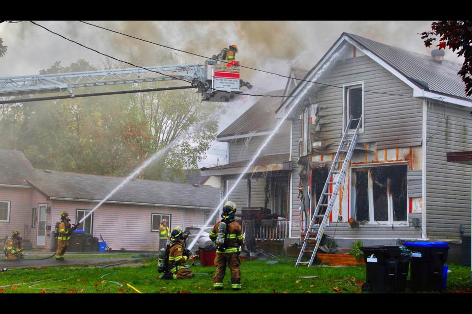 Firefighters battle a stubborn fire on George Street in Midland Wednesday. While there were no injuries, a family is now homeless as a result of the blaze.