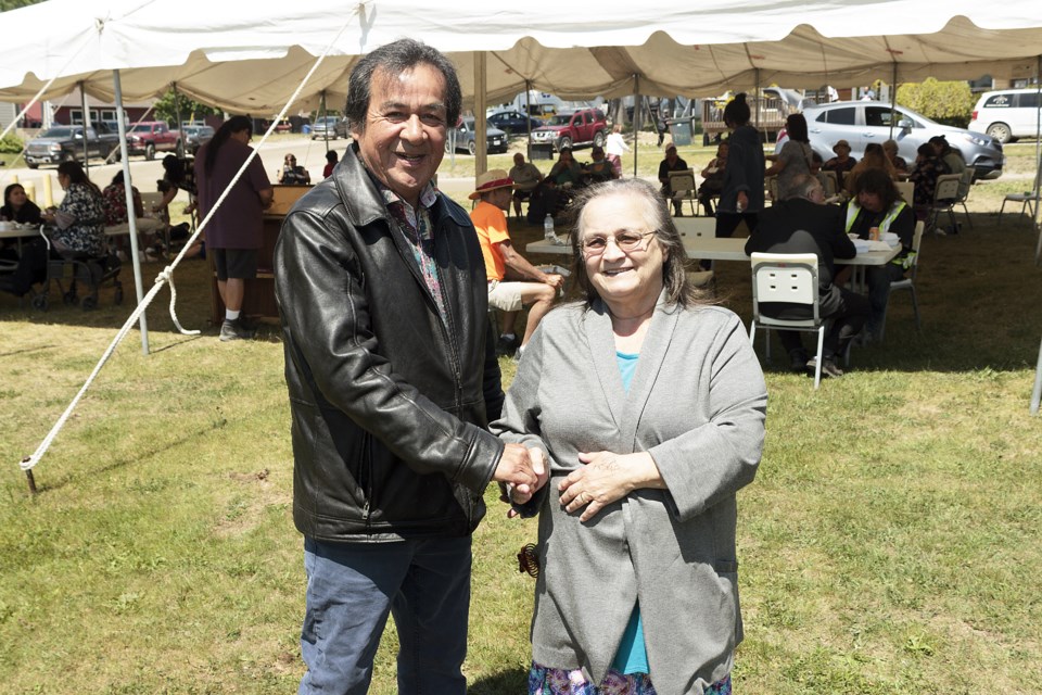 One enters as the other exits. Newly inaugurated Beausoleil First Nation Chief Joanne P. Sandy (right) holds the hand of previous Chief Guy Monague.