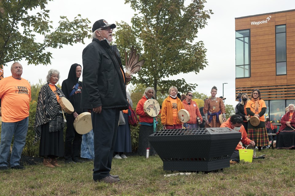 Brian George, Fish Clan (Potawatomi), traditional healing coordinator and health promoter at Chigamik, stood next to the etched Every Child Matters sacred fire, to speak words of healing and hope to the dozens of attendees.