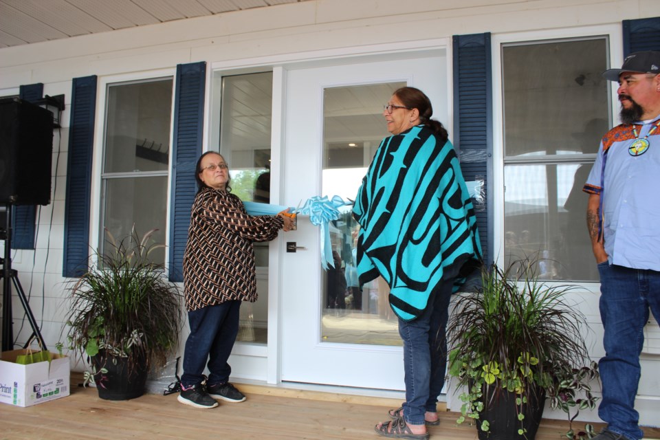 BFN Chief Joanne Sandy cuts the ribbon as OSMH director looks on. Sandy says the machines will allow residents to get care close to home.