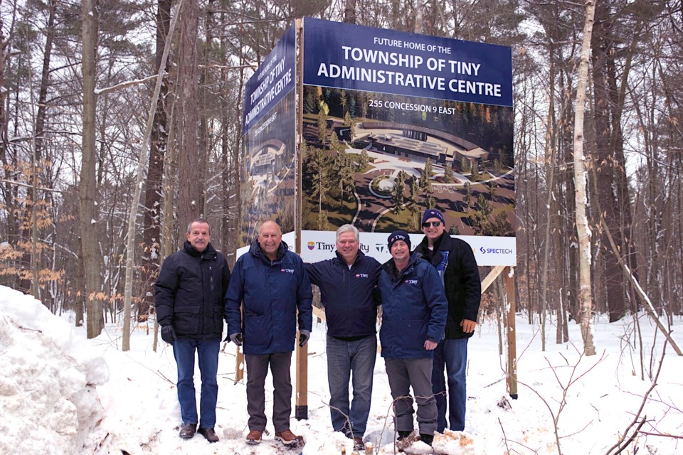 A sign for the new location of the Tiny Township Administrative Centre at 255 Concession 9 East was installed on Friday, with an anticipated construction completion date of 2027. From left to right: public works director Tim Leitch; Coun. Kelly Helowka; Mayor Dave Evans; Deputy Mayor Sean Miskimins; and CAO Robert Lamb.