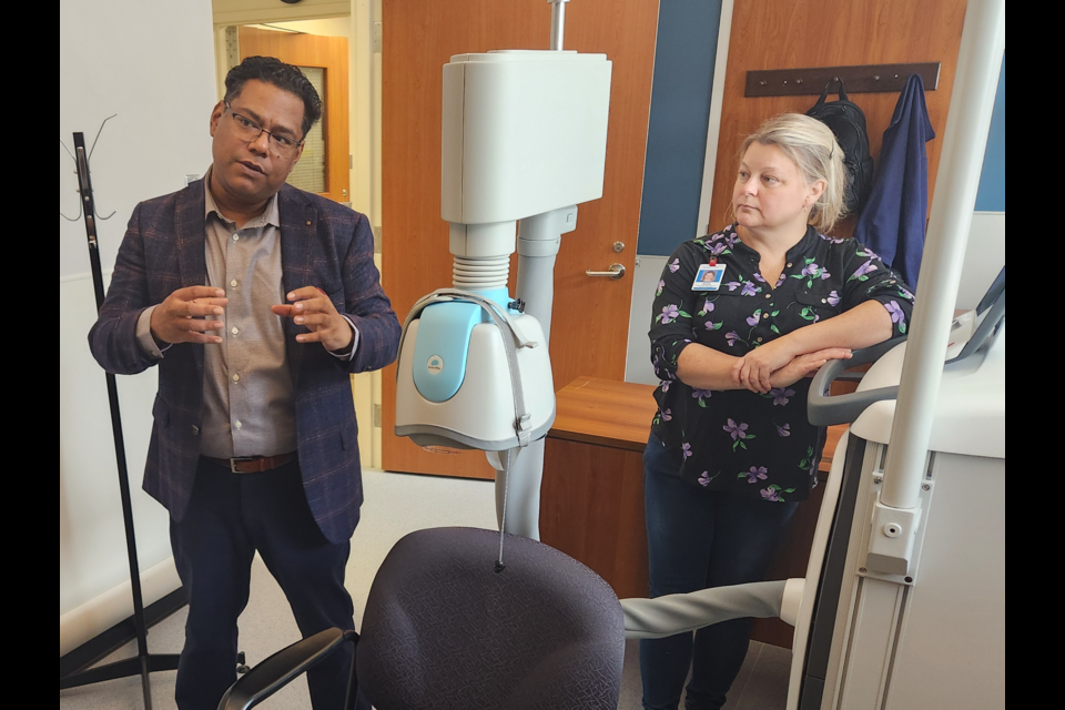 Waypoint's Dr. Plabon Ismail discusses how the rTMS machine works as Bayview and neuromodulation program clinical manager Michelle LaFraugh looks on.