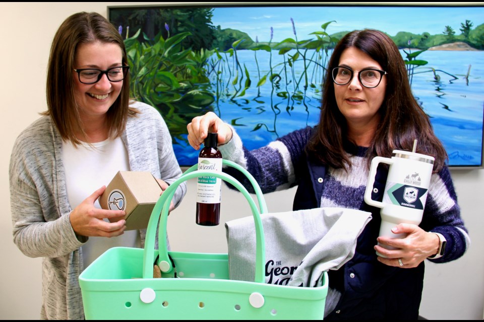 Jen Russell, director of communications and engagement at the Georgian Bay General Hospital Foundation is seen with volunteer Marie Holloway and one of the last Georgian Bay Bags.