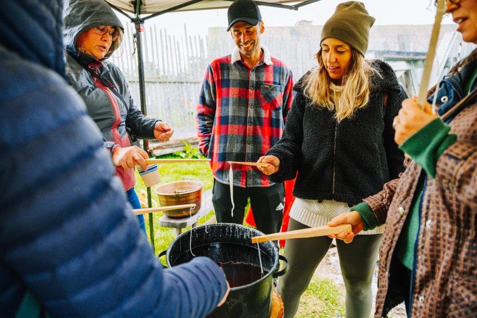 Guests are invited to make candles using the traditional dipping method at Sainte-Marie among the Hurons’ Hometown Harvest Festival.