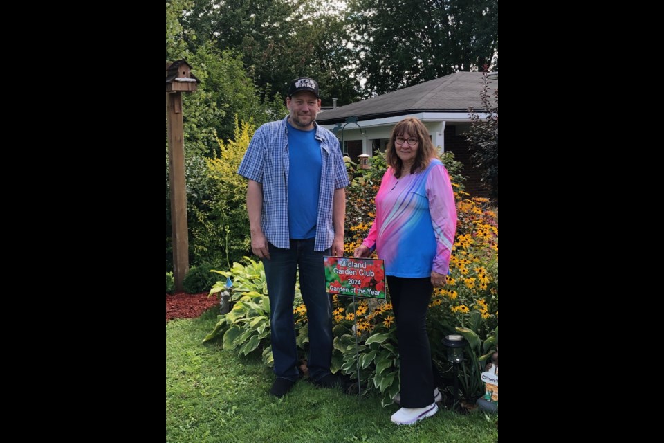 Susan and Damian Ash are pictured in front of the garden at their Bayview Avenue home.