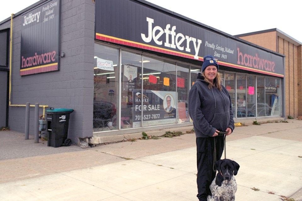 Shari Miller, with pet dog Reba, stand outside the family store Jeffery's Hardware which is closing on November 30 after 123 years of serving Midland.