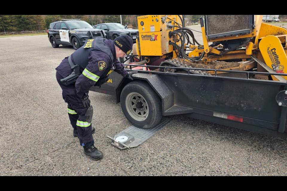 An officer checks a commercial vehicle during a safety blitz Tuesday, Nov. 19, 2024, in Midland.