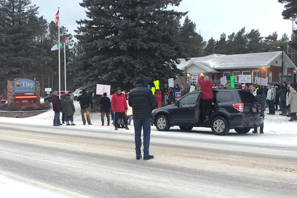 Roughly 150 protesters stood outside the 60-year-old Tiny Township municipal offices on Wednesday before the regular meeting of council, in protest of a new municipal building scheduled to be built.